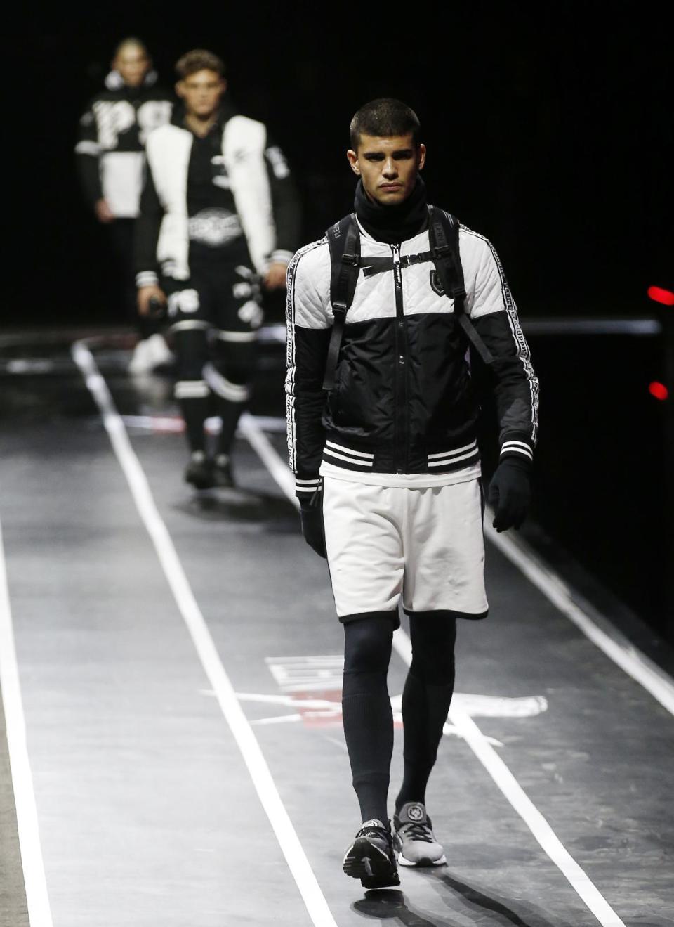 Models wear creations for Plein Sport men's Fall-Winter 2017-2018 collection, part of the Milan Fashion Week, unveiled in Milan, Italy, Saturday, Jan. 14, 2017. (AP Photo/Antonio Calanni)