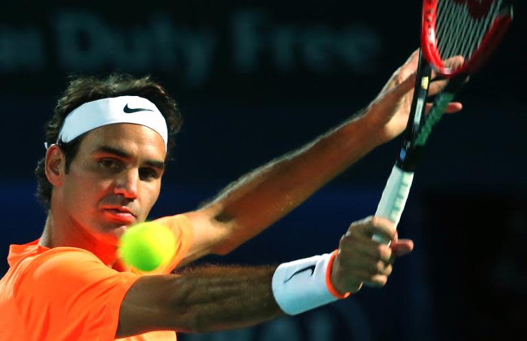 Roger Federer of Switzerland returns the ball to Richard Gasquet on the fourth day of the ATP Dubai Duty Free Tennis Championships on February 26, 2015 in Dubai