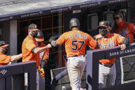 Baltimore Orioles' Hanser Alberto (57) celebrates with staff wearing protective masks after scoring on an RBI single hit by Ryan Mountcastle off New York Yankees starting pitcher Jordan Montgomery in the sixth inning of a baseball game, Saturday, Sept. 12, 2020, in New York. (AP Photo/John Minchillo)