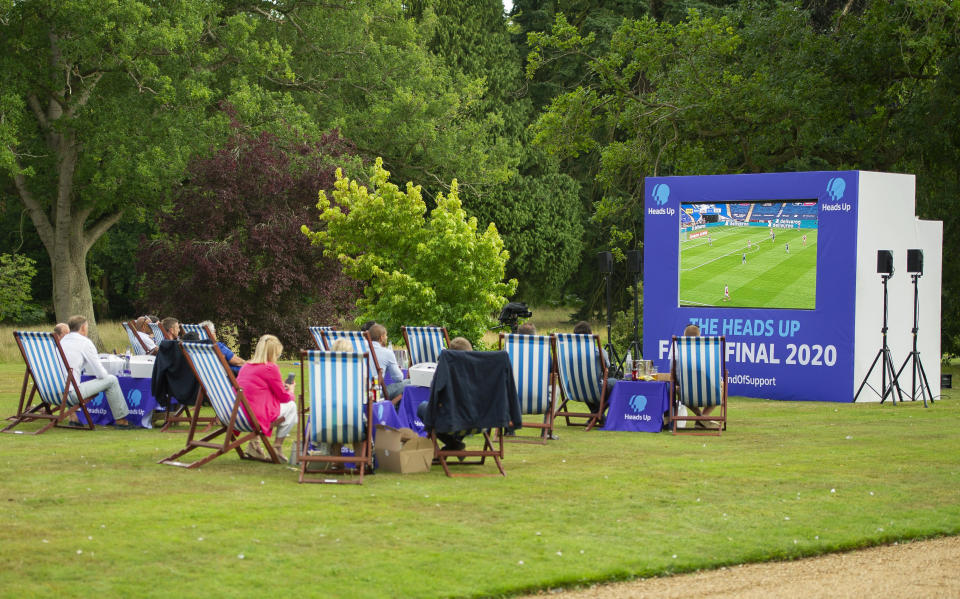 Britain's Prince William sits with representatives from Heads Up, Calm, Mind and Shout, and frontline workers from Norfolk, during a screening of the Heads Up FA Cup Final between Arsenal and Chelsea, at the Sandringham Estate to mark the culmination of the Heads Up campaign, in Norfolk, England, Saturday, Aug. 1, 2020. (Tim Merry/Pool Photo via AP)