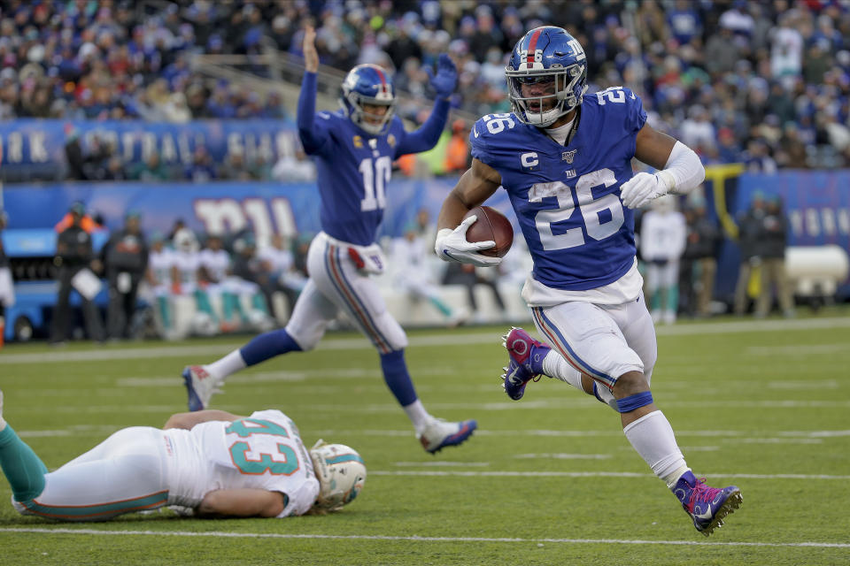 New York Giants running back Saquon Barkley (26) runs the ball into the end zone for a touchdown against the Miami Dolphins during the third quarter of an NFL football game, Sunday, Dec. 15, 2019, in East Rutherford, N.J. (AP Photo/Seth Wenig)