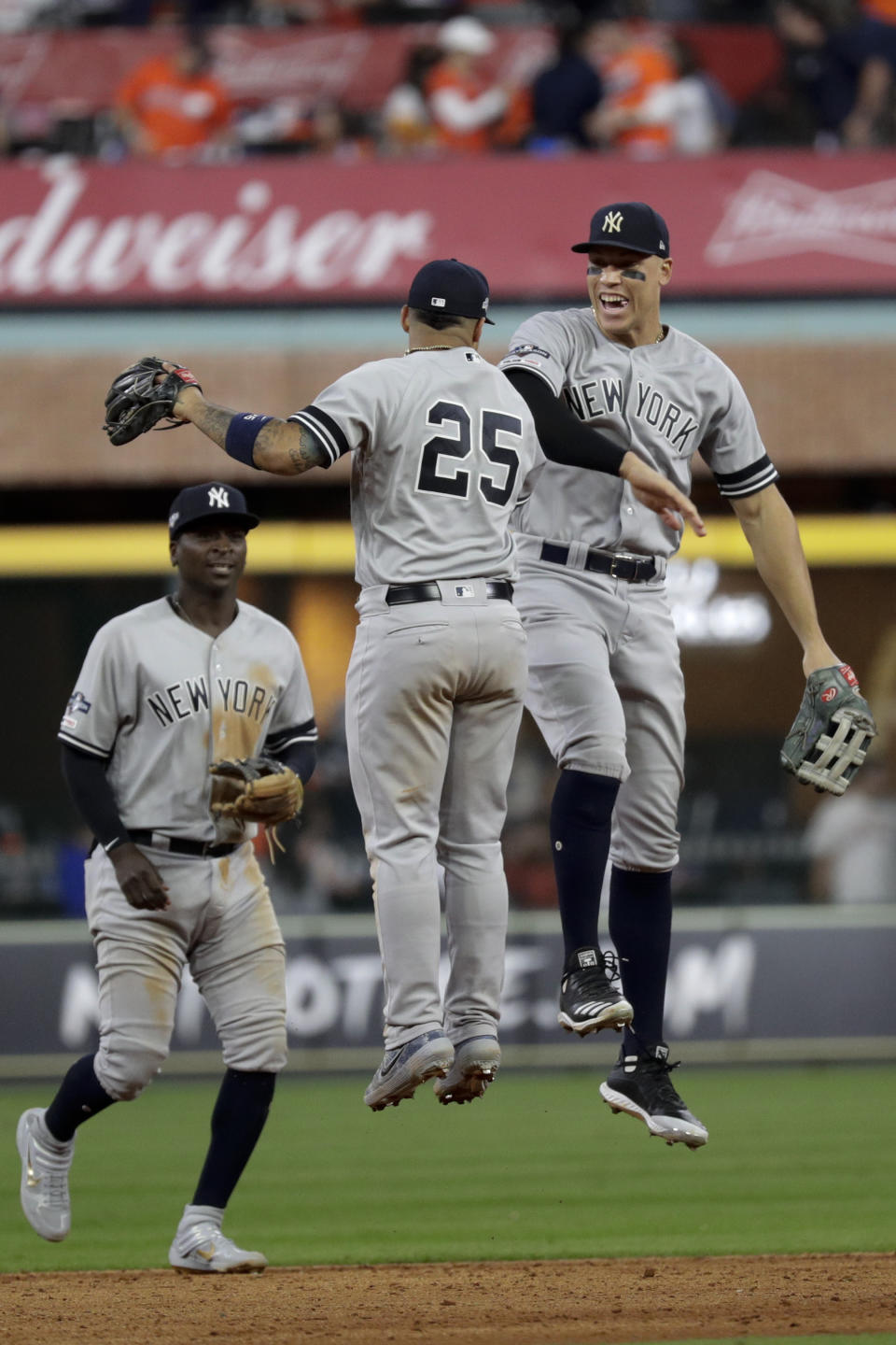 New York Yankees second baseman Gleyber Torres (25), and right fielder Aaron Judge celebrate after their win against the Houston Astros in Game 1 of baseball's American League Championship Series Saturday, Oct. 12, 2019, in Houston.(AP Photo/Eric Gay)