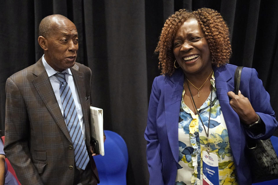 Mayor Acquanetta Warren, right, of Fontana, Calif., laughs while listening to Houston Mayor Sylvester Turner after a voting rights breakout session Tuesday, Sept. 20, 2022, in Houston. The National Nonpartisan Conversation on Voting Rights is holding meetings and seminars in Houston Tuesday and Wednesday. (AP Photo/David J. Phillip)