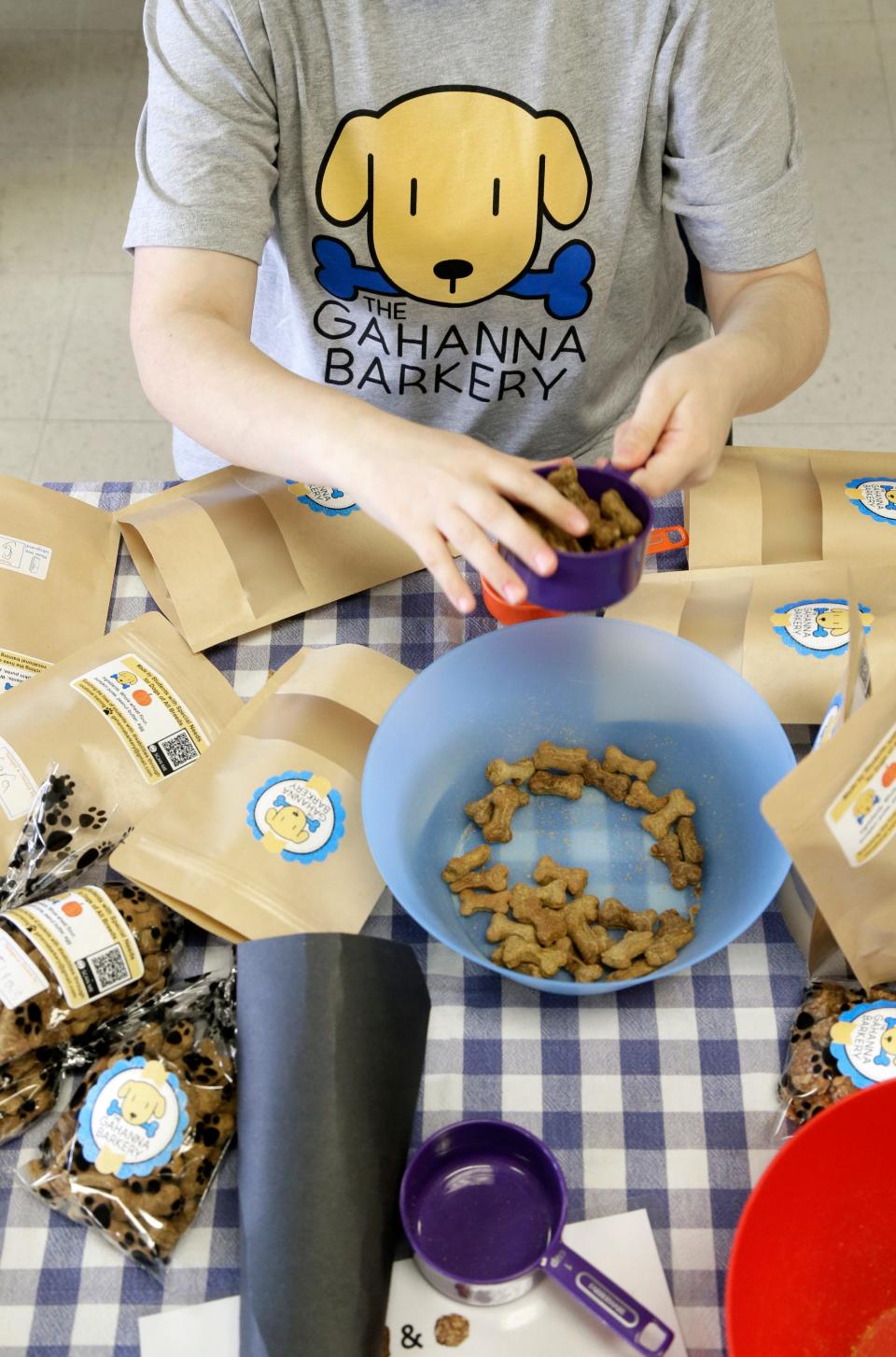 Sara Zeches, 16, packages dog treats at Gahanna Lincoln High School. Students in the school's special education program make, bake, package, label, weigh and sell the treats at part of the Gahanna Barkery.