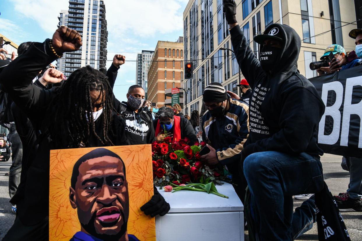 <p>Demonstrators participate in the ‘I Can’t Breathe - Silent March for Justice’ in front of the Hennepin County Government Center on 7 March 2021</p> (AFP via Getty Images)