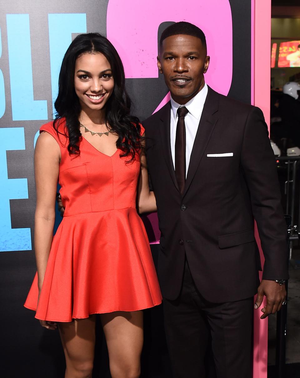 Jamie Foxx is recovering at home following a medical complication, his daughter revealed on May 12, 2023. The father and daughter are seen here in a Nov. 20, 2014, file photo arriving at the Los Angeles premiere of "Horrible Bosses 2."