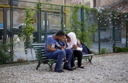 Syrian refugee Suhila (R), 50, looks at Rashid, 18, and Riad, 2, as they play following an interview with Reuters at Sant'Egidio community in Rome, Italy, April 20, 2016. REUTERS/Max Rossi