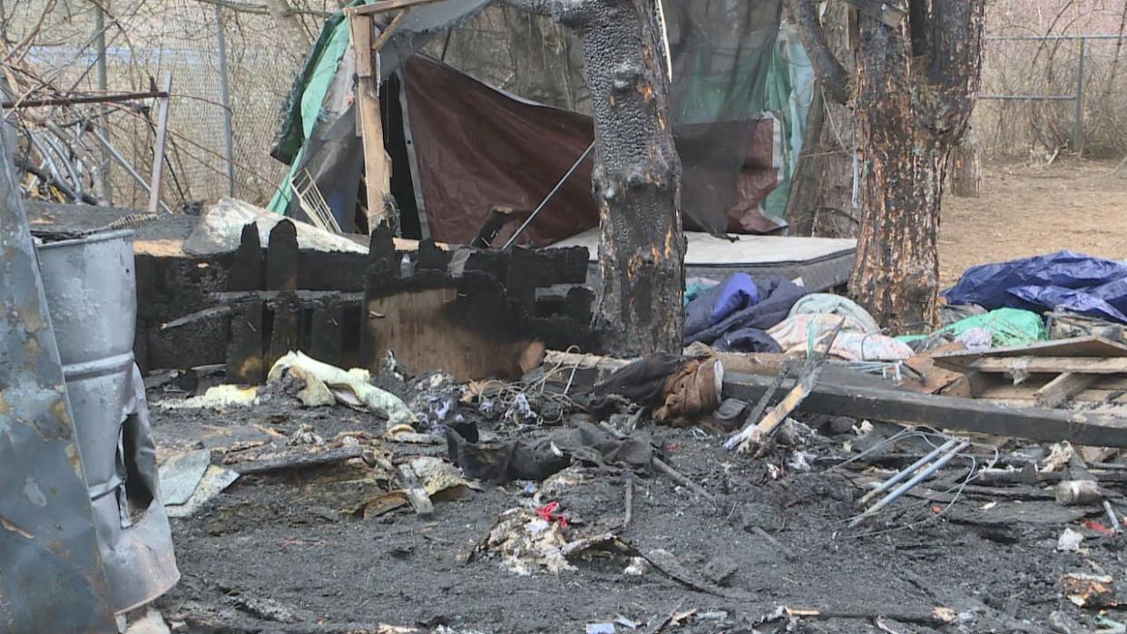 Burnt remains at the scene of a fire, that claimed one life, at a homeless encampment in Saint John. (Lars Schwarz/CBC - image credit)