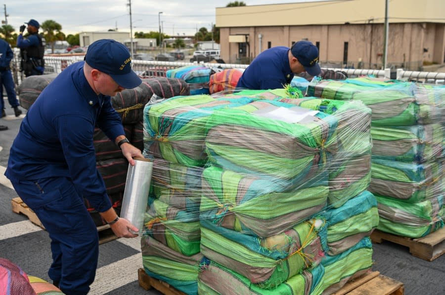 Crew of Coast Guard Cutter Resolute saran wraps illegal narcotics on the helo deck, Jan. 29, 2024, St. Petersburg, FL. The drugs, once secured, are offloaded from the cutter and given to partner agencies for destruction. (U.S. Coast Guard photo by Petty Officer 3rd Class Nicholas Strasburg)