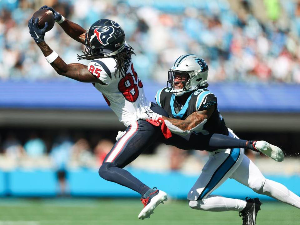 Houston Texans wide receiver Noah Brown, left, catches a pass in front of Carolina Panthers cornerback CJ Henderson at the Bank of America Stadium in Charlotte, N.C., on Sunday, October 29, 2023.