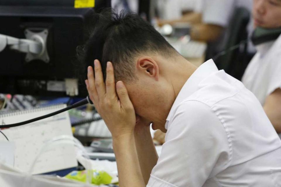 A City currency trader  (AP)