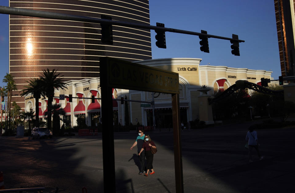 FILE - People cross Las Vegas Boulevard near the Wynn Las Vegas in Las Vegas. An effort by Nevada casino regulators to impose a $500,000 fine and discipline former Las Vegas casino mogul Steve Wynn over allegations of workplace sexual misconduct had new life Friday, April 1, 2022, after a state Supreme Court decision in a jurisdictional question. (AP Photo/John Locher, File)