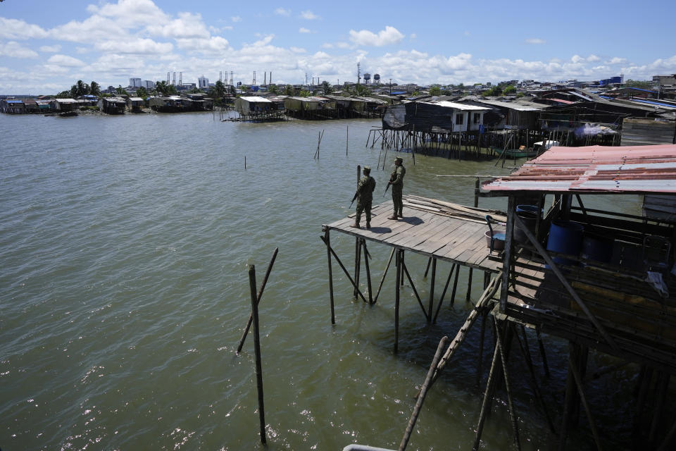 Navy soldiers stand guard in a "humanitarian space" of Buenaventura, Colombia, Wednesday, Aug. 16, 2023. Buenaventura’s “humanitarian space” is a former red zone transformed with the help of human rights groups as a place for community, safety and activism. (AP Photo/Fernando Vergara)