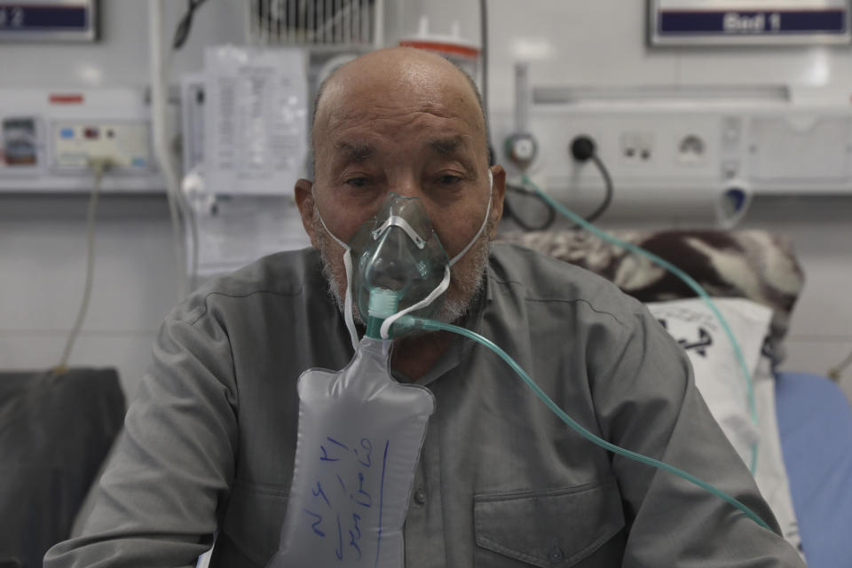 Afghan citizen Zamen Mousavi, a Covid-19 patient breathes with oxygen mask at the COVID-19 ICU ward of Amir Al-Momenin hospital in the city of Qom, some 80 miles (125 kilometers) south of the capital Tehran, Iran, Wednesday, Sept. 15, 2021. (AP Photo/Vahid Salemi)