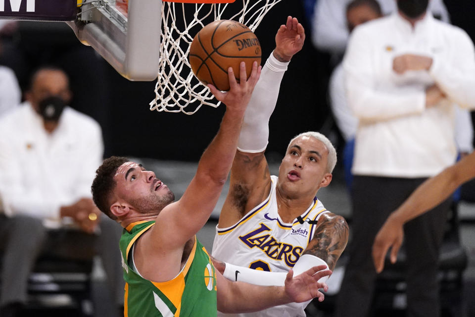 Utah Jazz forward Georges Niang, left, shoots as Los Angeles Lakers forward Kyle Kuzma defends during the first half of an NBA basketball game Saturday, April 17, 2021, in Los Angeles. (AP Photo/Mark J. Terrill)