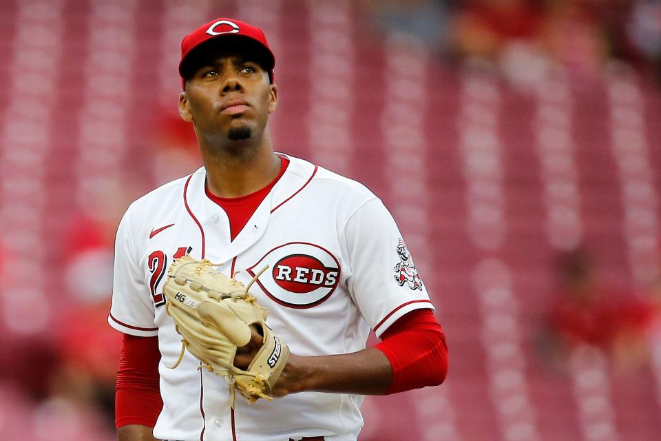 Cincinnati Reds starting pitcher Hunter Greene (21) resets between pitches in the fourth inning of the MLB National League game between the Cincinnati Reds and the Miami Marlins at Great American Ball Park in downtown Cincinnati on Tuesday, July 26, 2022.