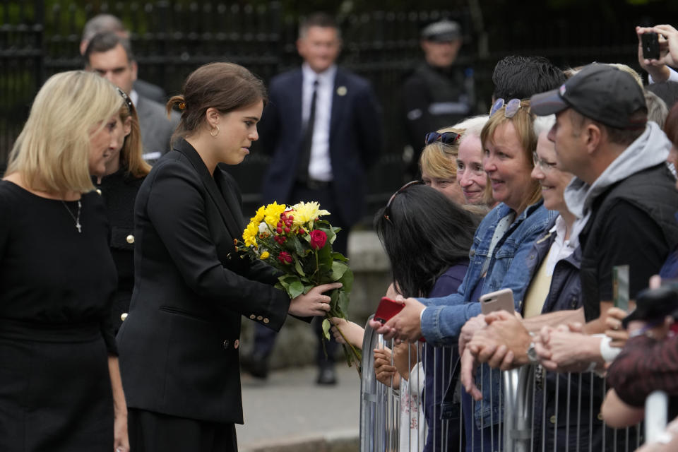 Princess Eugenie receives a bunch of flowers from a member of the public outside the gates of Balmoral Castle in Aberdeenshire, Scotland, Saturday, Sept. 10, 2022. Queen Elizabeth II, Britain's longest-reigning monarch and a rock of stability across much of a turbulent century, died Thursday after 70 years on the throne. She was 96. (AP Photo/Alastair Grant)