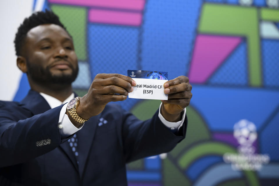 Former soccer player of Nigeria and ambassador for the UEFA Champions League final in London John Obi Mikel shows a ticket with Spanish soccer team Real Madrid CF name during the quarter-final draw of the UEFA Champions League 2023/24, at the UEFA Headquarters in Nyon, Switzerland, Friday, March 15, 2024. Real Madrid CF will face Manchester City FC in the quarter-final of the 2023/2024 UEFA Champions League. (Jean-Christophe Bott/Keystone via AP)