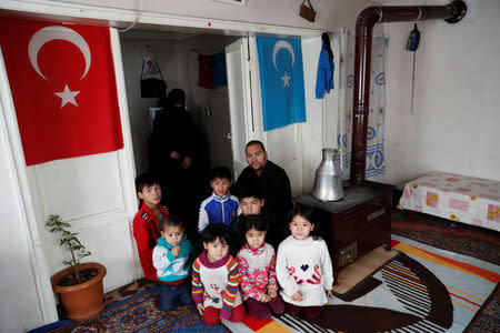 Abdulaziz Abdulvahid, a 39-year-old Uighur man who has health problems and survives on Red Crescent aid, poses with his wife and seven children at their home in Kayseri, Turkey, January 31, 2019. REUTERS/Murad Sezer