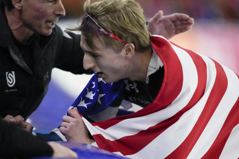 Jordan Stolz of the U.S. celebrates with a member of the U.S. speed skating team after winning his third gold medal on the 1500m Men event of the Speedskating Single Distance World Championships at Thialf ice arena Heerenveen, Netherlands, Sunday, March 5, 2023. (AP Photo/Peter Dejong)