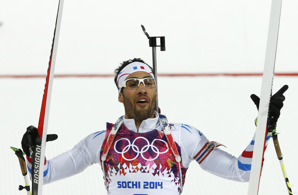 France's Martin Fourcade celebrates winning the gold during the men's biathlon 12.5k pursuit, at the 2014 Winter Olympics, Monday, Feb. 10, 2014, in Krasnaya Polyana, Russia. (AP Photo/Felipe Dana)