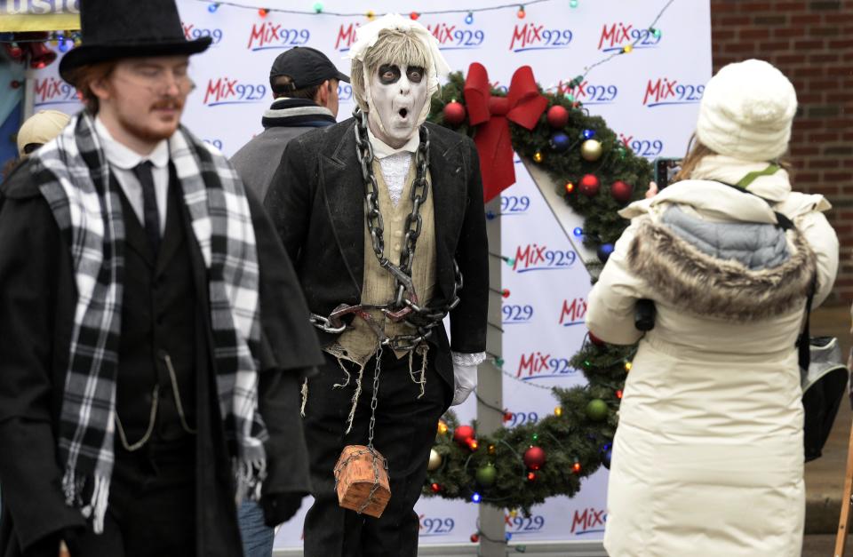 John Kitson, center, dresses up as ghost Jacob Marley, interacts with people during the 34th annual Dickens of a Christmas in downtown Franklin Dec. 8, 2018.