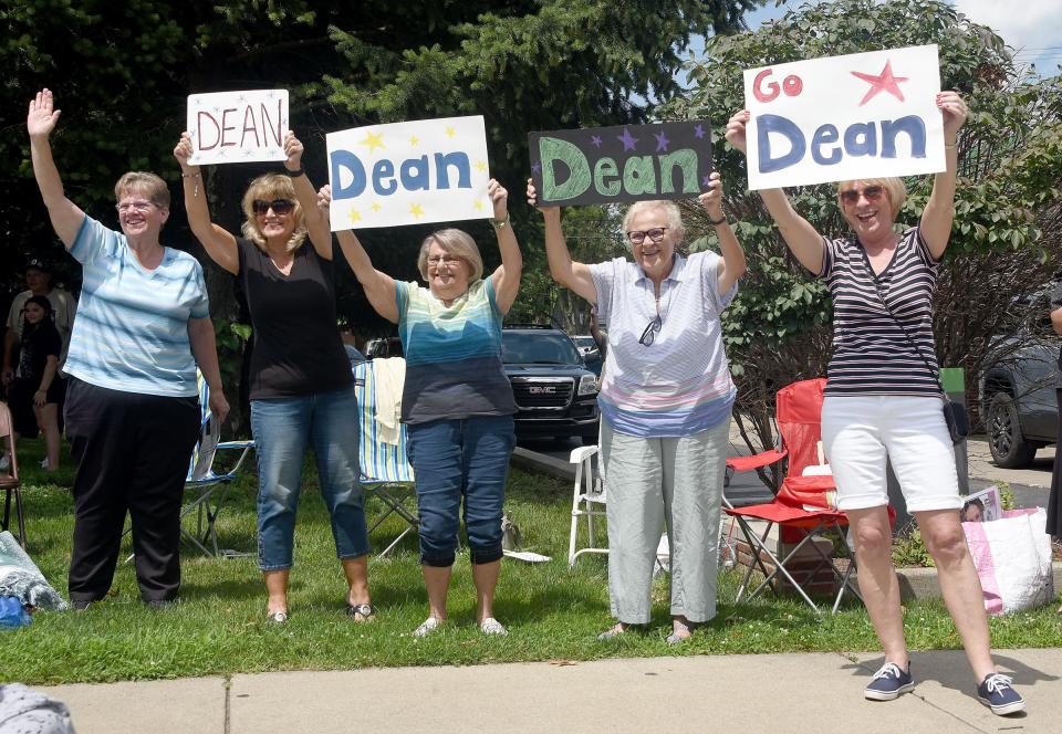 Former employees of The Monroe News, Janet Latondress, Vickie Price, Marge McBee, Deb Saul and Jeanine Bragg, cheer for this year's Monroe County Fair Parade Grand Marshal Dean Cousino, a long time, retired employee of The Monroe News.