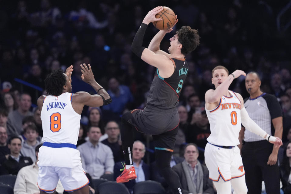 Washington Wizards forward Deni Avdija, center, goes to the basket against New York Knicks forward OG Anunoby, left, in the first half of an NBA basketball game Thursday, Jan. 18, 2024, at Madison Square Garden in New York. (AP Photo/Mary Altaffer)