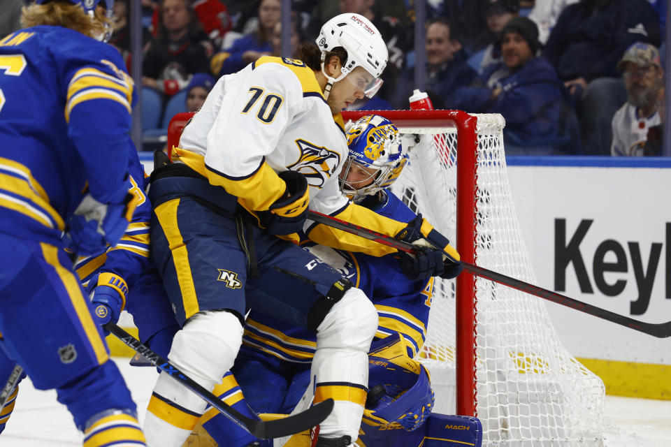 Nashville Predators left wing Egor Afanasyev (70) collides with Buffalo Sabres goaltender Craig Anderson (41) during the second period of an NHL hockey game, Tuesday, March 21, 2023, in Buffalo, N.Y. (AP Photo/Jeffrey T. Barnes)