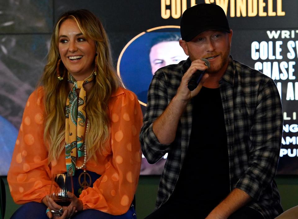 Cole Swindell speaks with Lainey Wilson as they celebrate at the “Never Say Never” No. 1 party at BMI on  July 13 in Nashville.