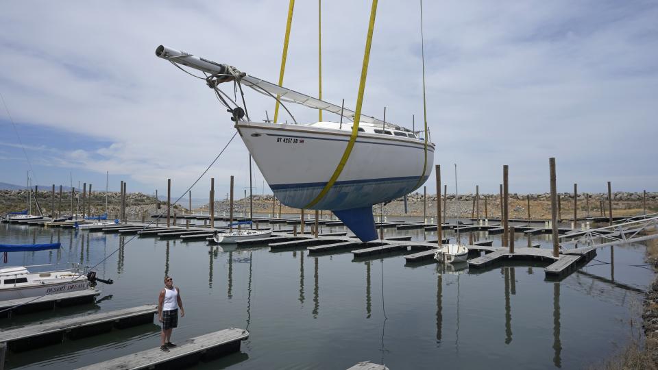 FILE - Sail boats are hoisted back into the Great Salt Lake Marina on June 6, 2023, in Magna, Utah. A coalition of environmental organizations sued the state of Utah on Wednesday, Sept. 6, 2023, based on accusations that it is not doing enough make sure enough water gets to the shrinking Great Salt Lake. (AP Photo/Rick Bowmer, File)