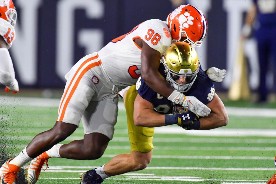 Clemson's Myles Murphy (98) tackles Notre Dame's Michael Mayer Nov. 5, 2022. Murphy was drafted by the Bengals in the first round in last week's NFL draft and Mayer in the second round by the Las Vegas Raiders.