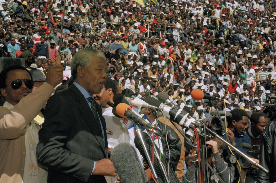 FILE — In this April 14, 1993 file photo taken by South African Photographer John Parkin, African National Congress President Nelson Mandela addresses a rally in Soweto as hundreds of thousands of Blacks went on strike to protest the assassination of South African Communist Party leader Chris Hani. Parkin, who covered the country's anti-apartheid struggle, its first democratic elections, and the presidency of Nelson Mandela, has died Monday Aug. 23, 2021, at the age of 63 according to his daughter. (AP Photo/John Parkin)