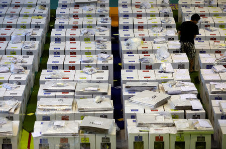 A worker prepares election materials to be distributed to polling stations at a sports hall in Jakarta, Indonesia April 16, 2019. REUTERS/Edgar Su