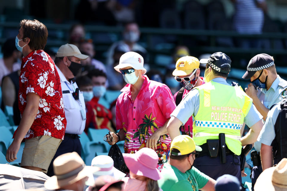 SYDNEY, AUSTRALIA - JANUARY 10: Police speak to spectators following a complaint from Mohammed Siraj of India that stopped play during day four of the Third Test match in the series between Australia and India at Sydney Cricket Ground on January 10, 2021 in Sydney, Australia. (Photo by Cameron Spencer/Getty Images)