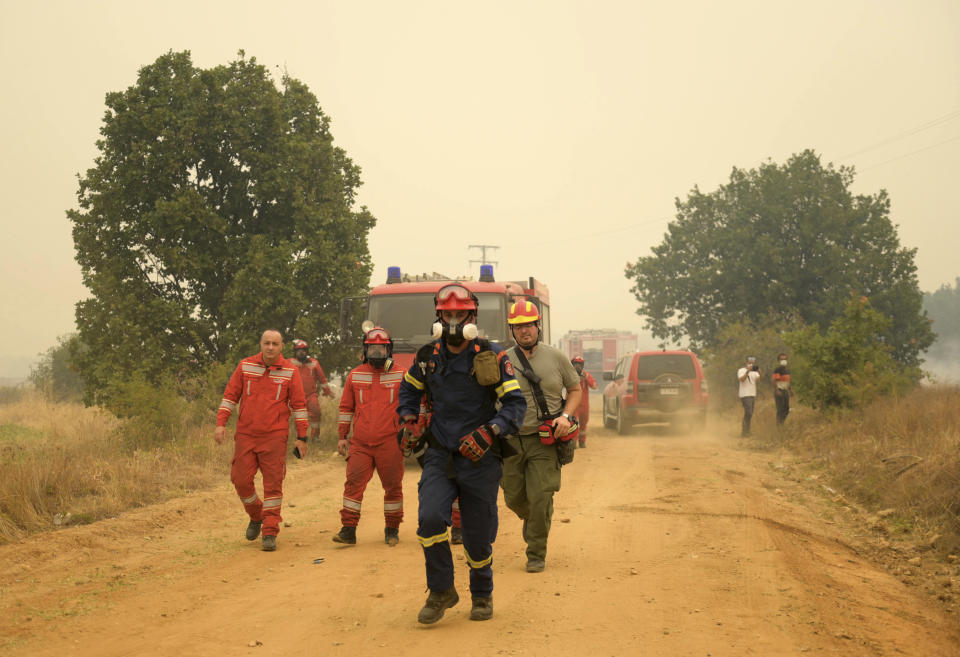Firefighters operate during a wildfire in Giannouli village, in the northeastern Evros region, Greece, Thursday, Aug. 31, 2023. Greek authorities have further reinforced firefighting forces in the country's northeast, where a massive blaze in its thirteenth day has flared up once more, triggering authorities to issue alerts to residents in the area to be on standby for possible evacuation. (e-evros.gr via AP)