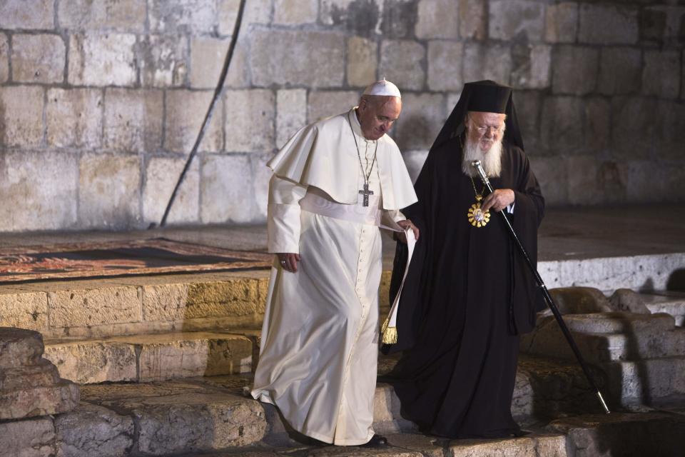 Ecumenical Patriarch of Constantinople Bartholomew walks with Pope Francis outside the Church of the Holy Sepulchre in Jerusalem's Old City