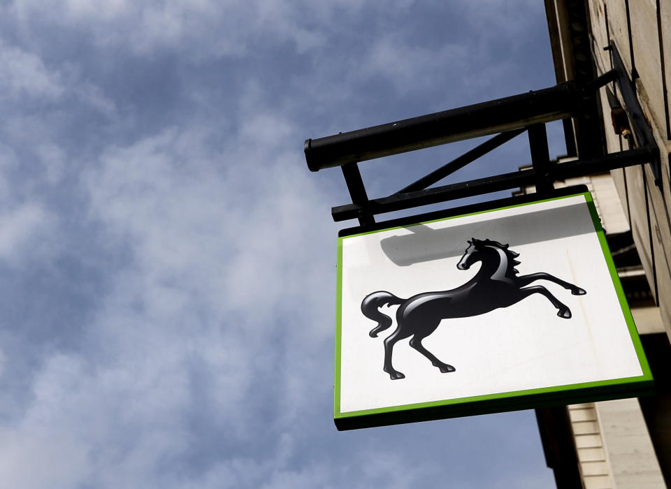 The logo hangs on a branch of Lloyds Bank in London, Thursday, July 28, 2016. Britain's Lloyds Banking Group said Thursday it plans to eliminate 3,000 jobs and close 200 branches — the first big cuts announced since Britain voted to leave the European Union. (AP Photo/Kirsty Wigglesworth)