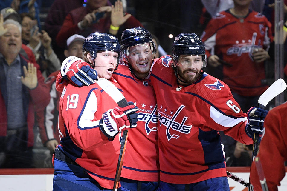 Washington Capitals center Nicklas Backstrom (19), of Sweden, celebrates his goal with defensemen John Carlson (74) and Michal Kempny (6), of the Czech Republic, during the first period of an NHL hockey game against the Winnipeg Jets, Sunday, March 10, 2019, in Washington. (AP Photo/Nick Wass)