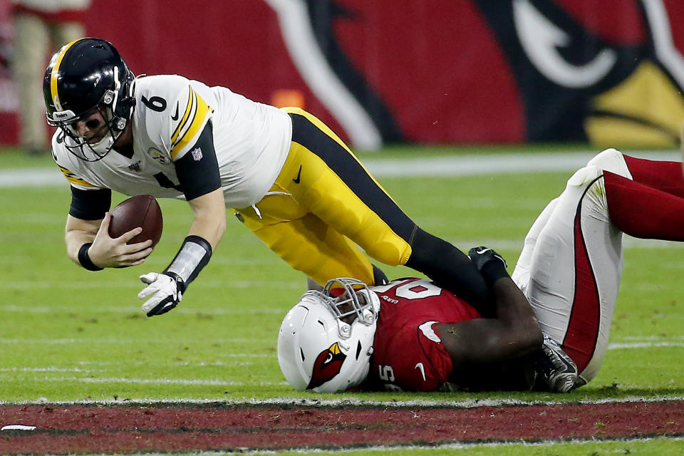 Pittsburgh Steelers quarterback Devlin Hodges (6) is tackled by Arizona Cardinals defensive tackle Rodney Gunter during the first half of an NFL football game, Sunday, Dec. 8, 2019, in Glendale, Ariz. (AP Photo/Rick Scuteri)