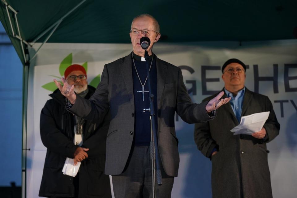 Imam Monawar Hussain (left) and Rabbi David Mason listen to listen to Justin Welby address the vigil on Richmond Terrace (Yui Mok/PA)