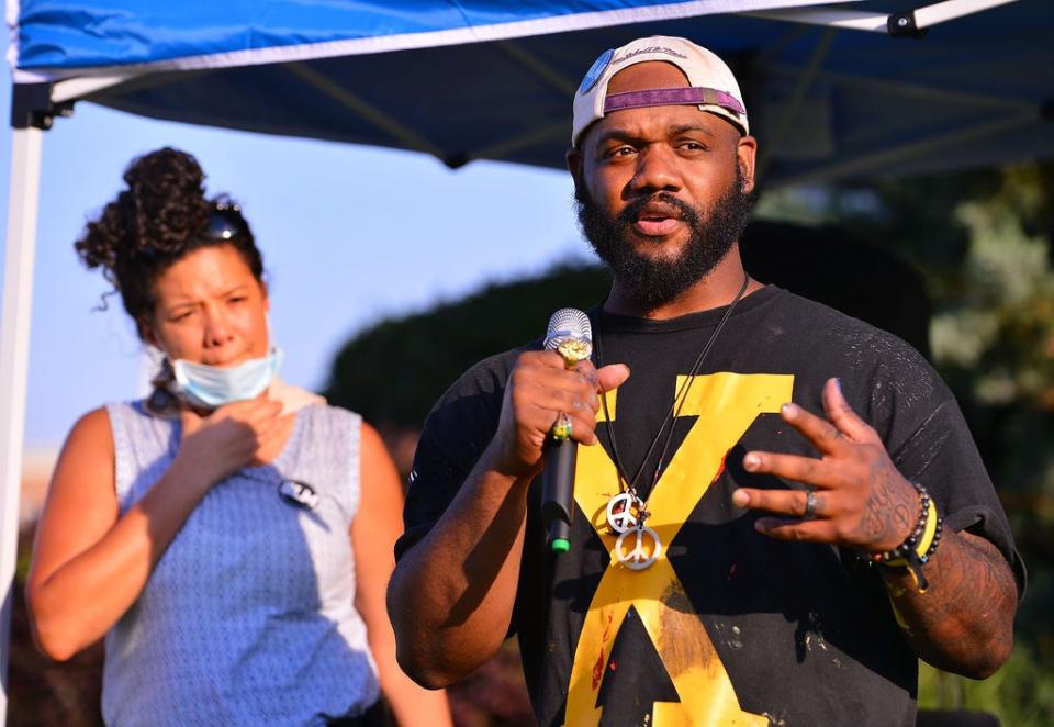 Sixteen artists, with help from community volunteers, joined together in painting a Black Lives Matter mural, stretching 240 feet along Broad Street in front of City Hall in downtown Spartanburg, Saturday, June 20, 2020. Artist Frankie Zombie speaks during the event.