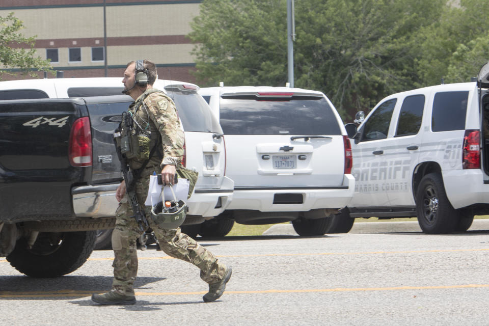 An FBI agent is seen in the parking lot of Santa Fe High School where at least ten people were killed on May 18, 2018 in Santa Fe, Texas.