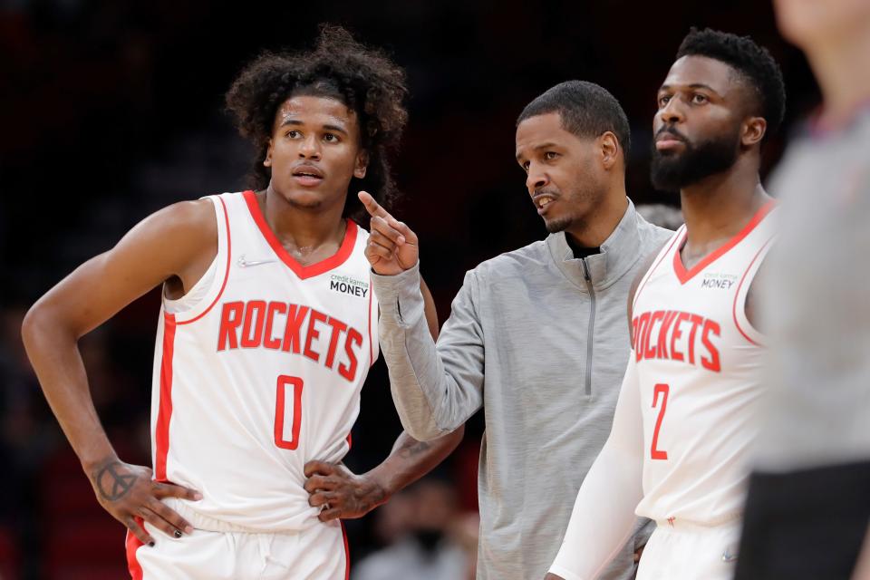 Houston Rockets head coach Stephen Silas, center, talks with guard Jalen Green (0) and forward David Nwaba (2) during a time out during the first half of an NBA basketball game against the Washington Wizards Tuesday, Oct. 5, 2021, in Houston. (AP Photo/Michael Wyke)