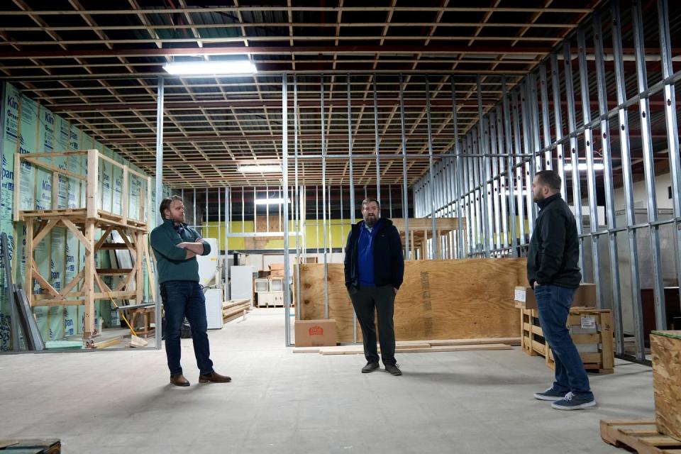 Left to right, A.J. Kilroy, company president; Nate Tessier, head brewer; and Robert Russell, operations manager, in the future taproom for Iron Stag Brewing at Rolfe Square in Cranston.