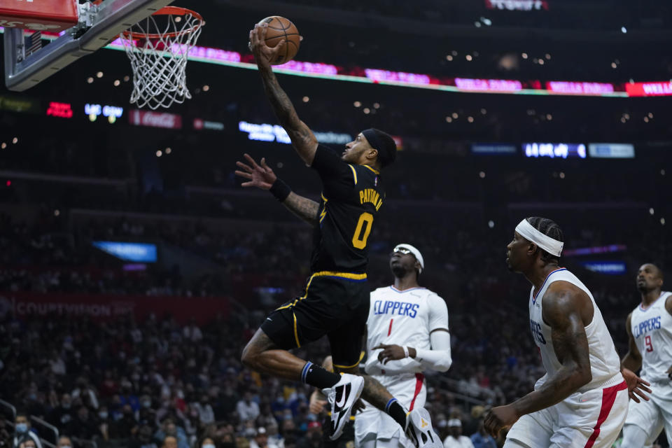 Golden State Warriors guard Gary Payton II (0) shoots during the first half of an NBA basketball game against the Los Angeles Clippers in Los Angeles, Sunday, Nov. 28, 2021. (AP Photo/Ashley Landis)