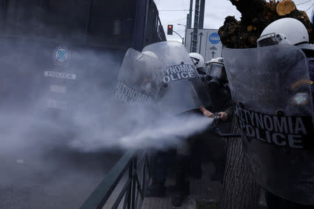 Riot police uses tear gas during clashes with protesters demonstrating outside the parliament building against government plans to change hiring procedures in the public sector in Athens, Greece, January 14, 2019. REUTERS/Alkis Konstantinidis