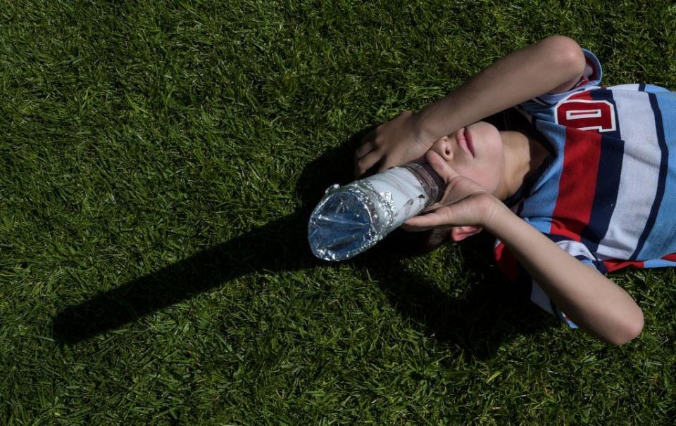 A boy uses a DIY tube viewer to watch the partial solar eclipse in Bogota on August 21, 2017.