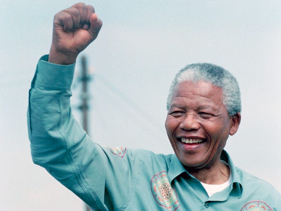 Nelson Mandela acknowledges a crowd of ANC supporters April 21, 1994 at a pre-election rally in Durban days before the historic democratic election on April 27, 1994 in South Africa. Mr Mandela became the first black democratic elected president in South Africa. He retired from office after one term in June 1999