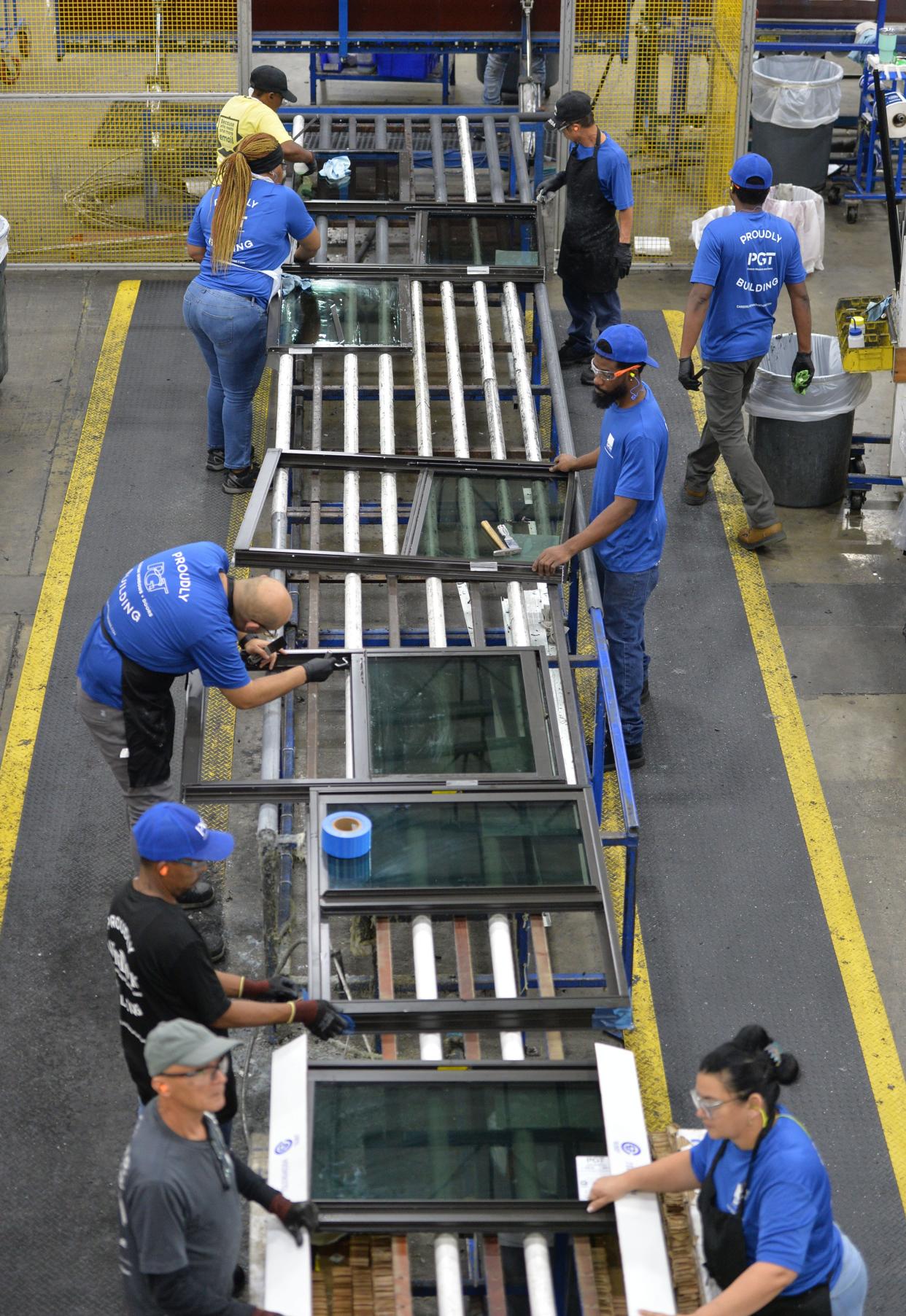 PGT employees assemble windows on the production floor of the PGT manufacturing facility in Venice on Nov. 16, 2023.